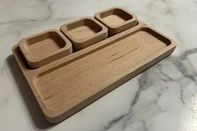 A cherry bar tray with recessed compartments.