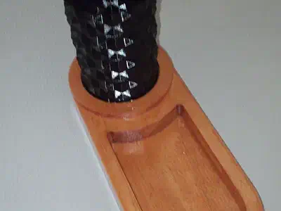 Finished maple catch-all tray with a dark upright insert holding a remote control