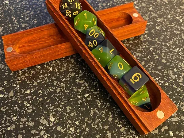 Long orange-finished wooden holder with a row of dice pockets, resting across its matching lid