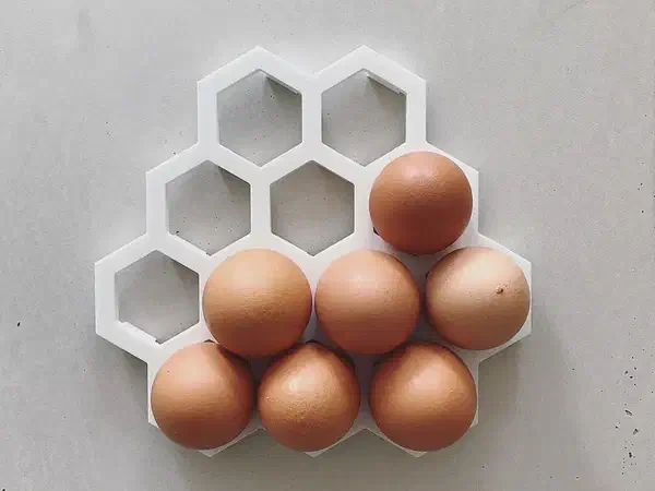 A white honeycomb egg tray made from Corian