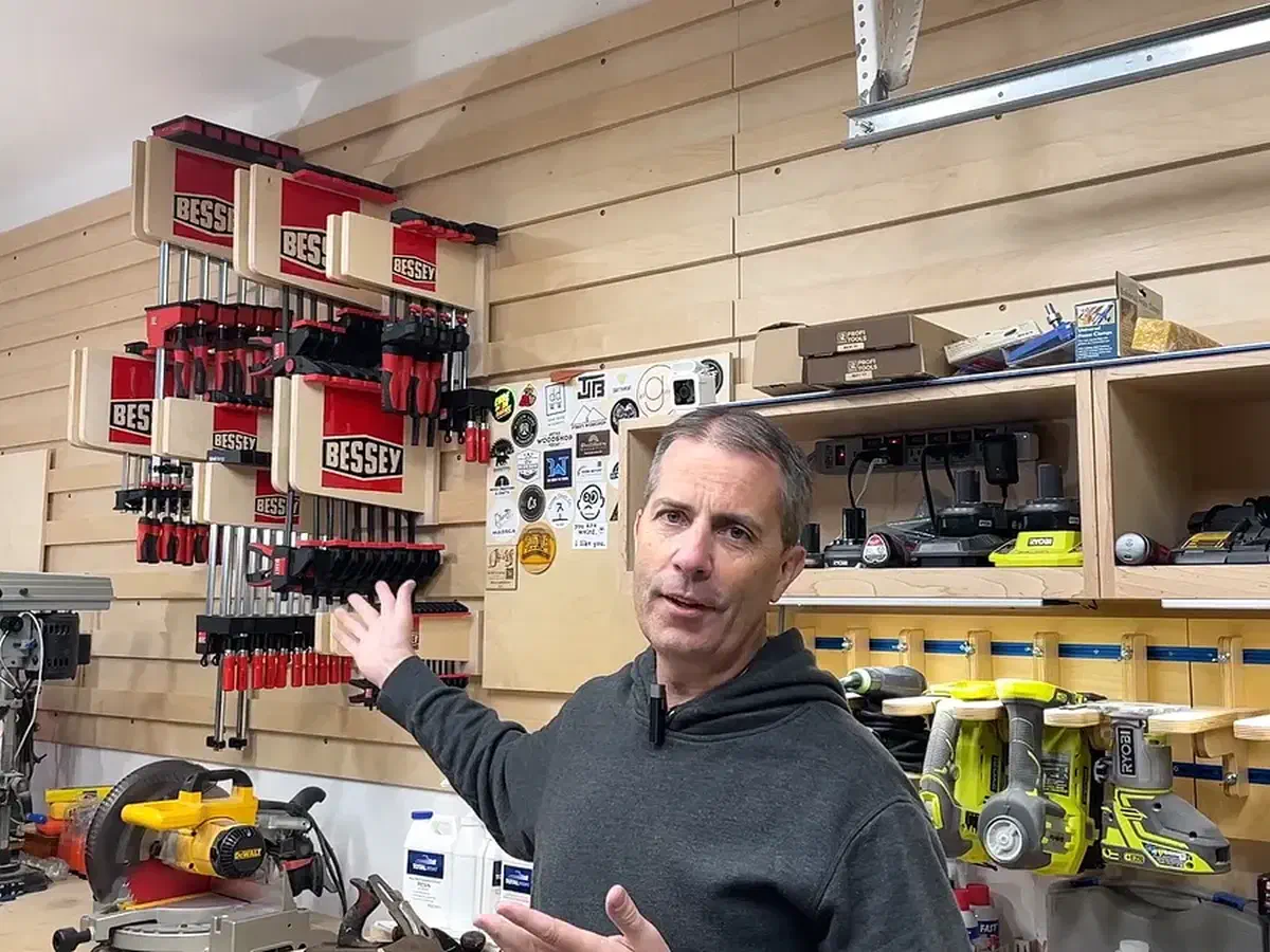 Finished plywood clamp racks with red epoxy Bessey logos installed and loaded with clamps