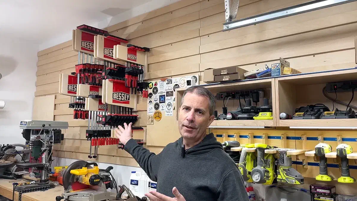 Finished plywood clamp racks with red epoxy Bessey logos installed and loaded with clamps