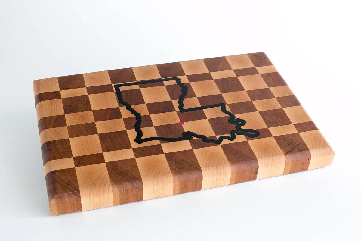 Finished checkerboard end-grain cutting board with a dark epoxy state outline inlay