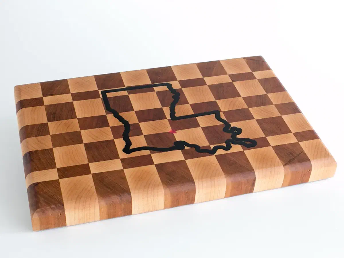 Finished checkerboard end-grain cutting board with a dark epoxy state outline inlay