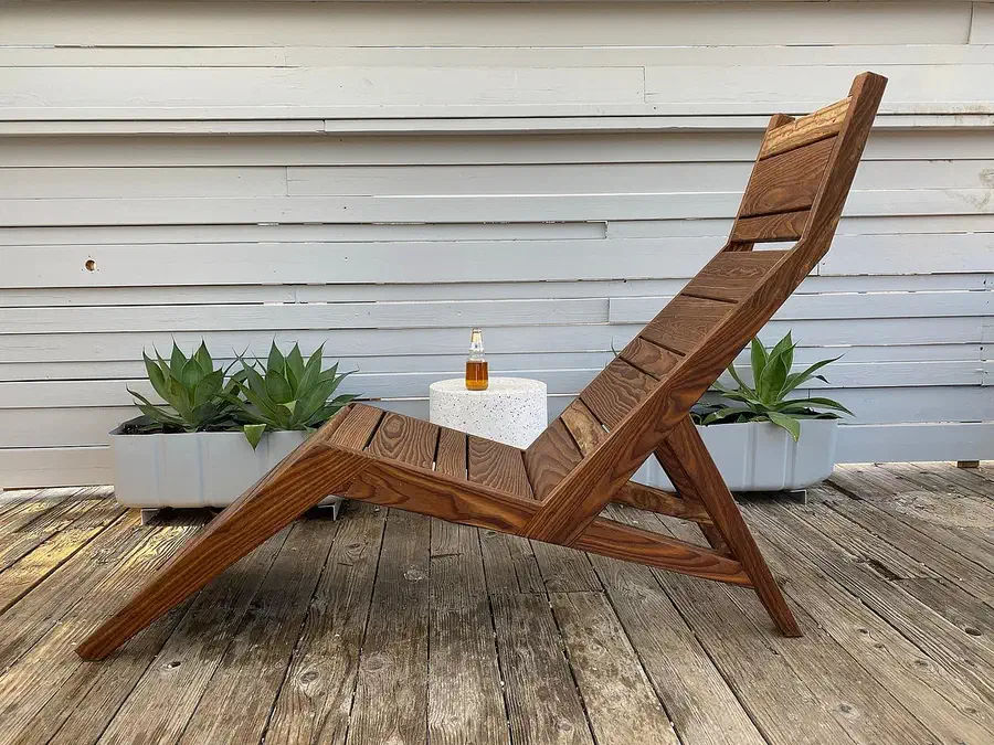 Finished slatted wood lounge chair on an outdoor deck