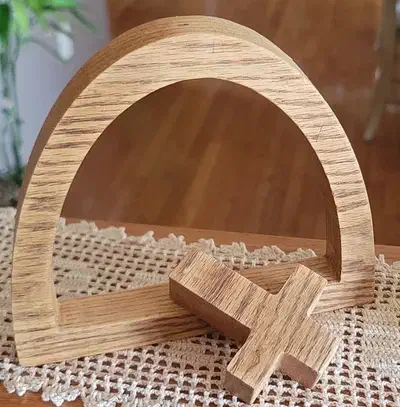 Complete wooden arch and separate cross resting on a lace-covered table
