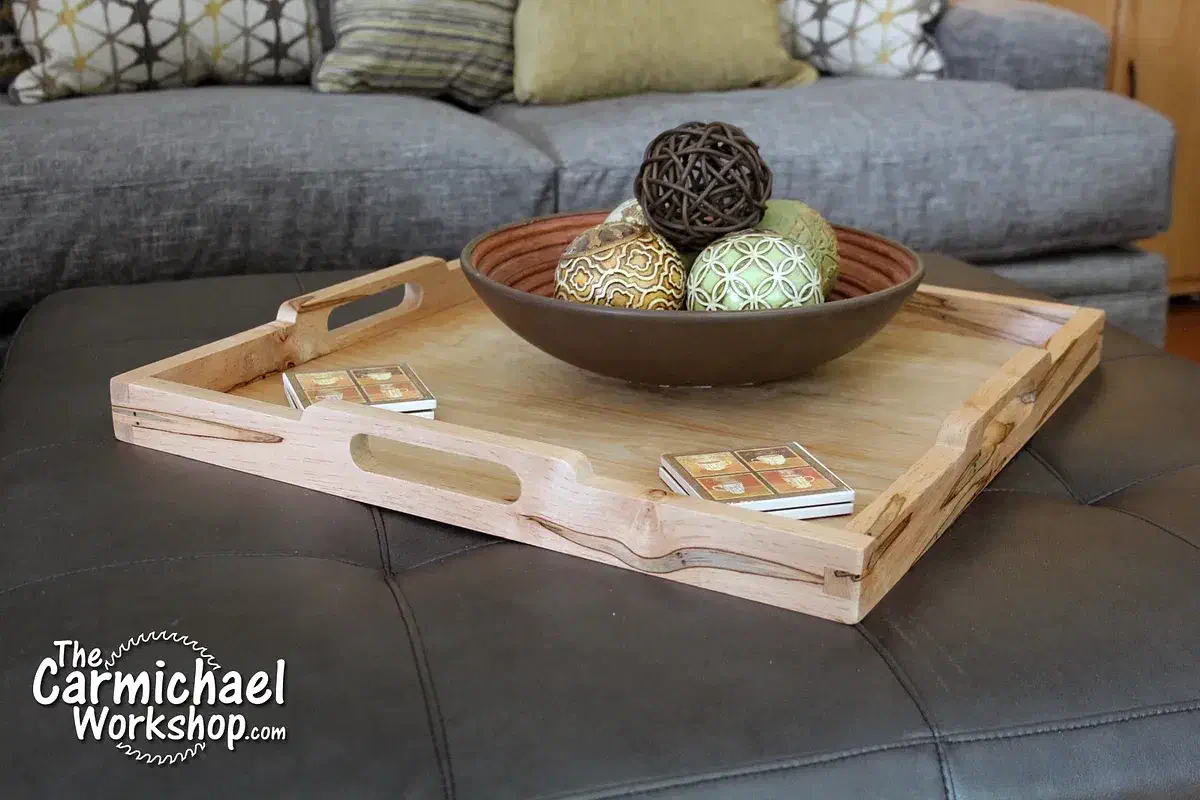 An ambrosia maple serving tray with cutout handles and finger-jointed corners on a table