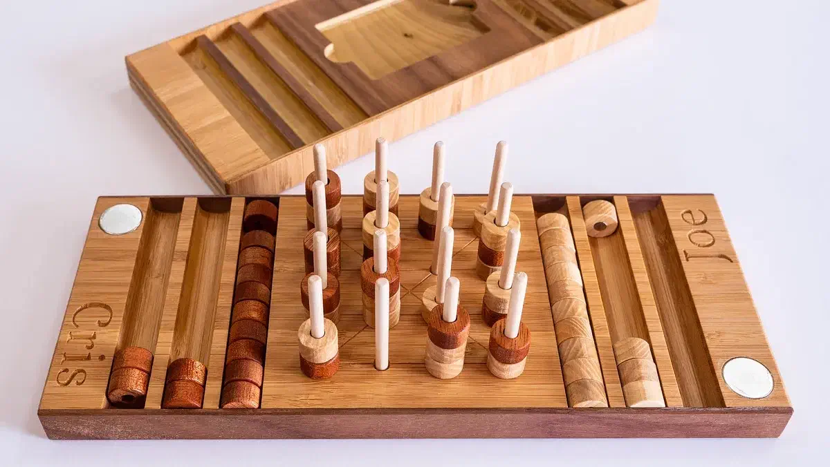 Cristiana Felgueiras’s wooden three-dimensional four-in-a-row game with dowels, counters and an open case