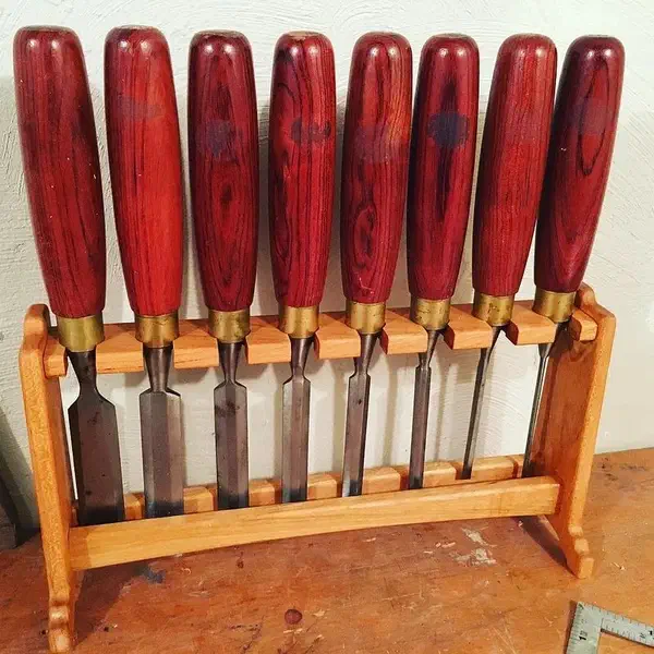 Nikolaus Brown’s freestanding wooden chisel rack holding red-handled chisels