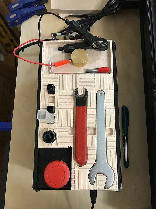 Maple tool tray on a controller with a caliper, wrench and red probe