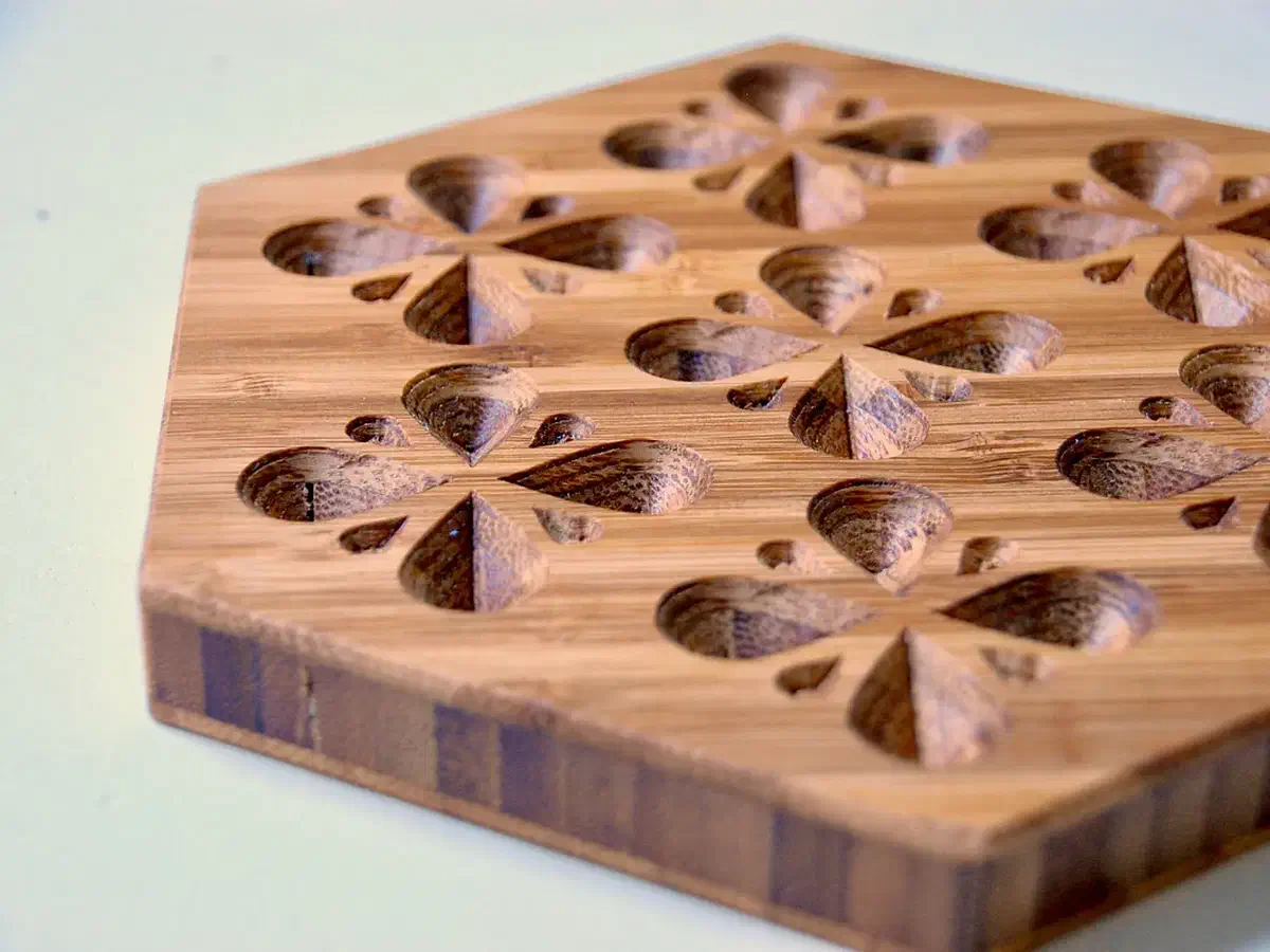 Bamboo trivet with carved teardrop clusters