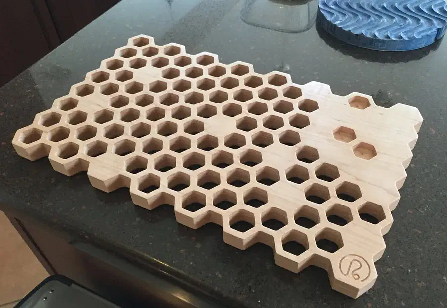 Large pale honeycomb trivet with many open hexagonal holes