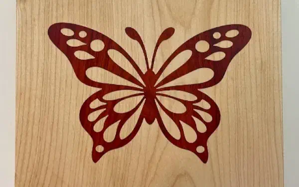 A V-carve inlay with a contrasting wood plug seated in a pocket