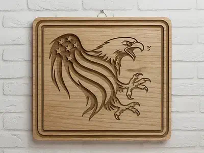 An eagle with an American flag wing carved into a square wood plaque